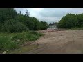 При движении от круга ТЦ Мега, в сторону кладбища, в конце коричневого мпеталлопрофильного забора.