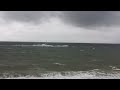 Strong winds and waves as speed boat high speeds through