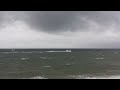 Strong winds and waves as speed boat high speeds through