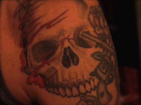 Guns N' Roses and Velvet Revolver shows his tattoos at a music show
