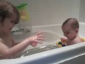 Funny giggling cute baby in bath.