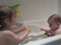 Funny giggling cute baby in bath.