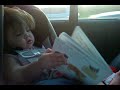 Funny 12months baby reading in the car