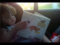 Funny 12months baby reading in the car