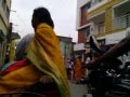 A INDIAN GIRL IN TRAFFIC WITH HER CYCLE