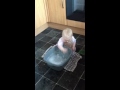 Funny baby cleaning the floor