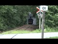 Danish steam train LJ 19 passes railroad crossing towards Maribo