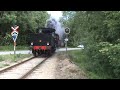 Danish steam train LJ 19 passes railroad crossing towards Maribo