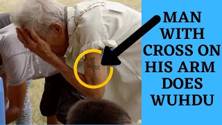 MAN WITH A CROSS ON ARM DOES ISLAMIC ABLUTION