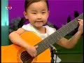 North Korea children playing the guitar. Creepy as hell.
