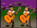 North Korea children playing the guitar. Creepy as hell.