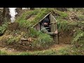 Building complete and warm survival shelter  Bushcraft earth hut, grass roof & fireplace with clay