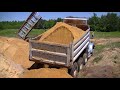 GMC and International Dump Trucks Dumping Sand