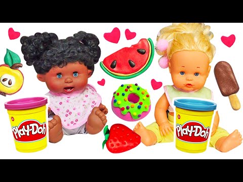 Baby dolls are making Play-Doh breakfast and Play-Doh ice cream at the toy kitchen.