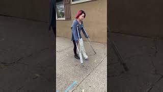 AJ crutching through down sidewalk
