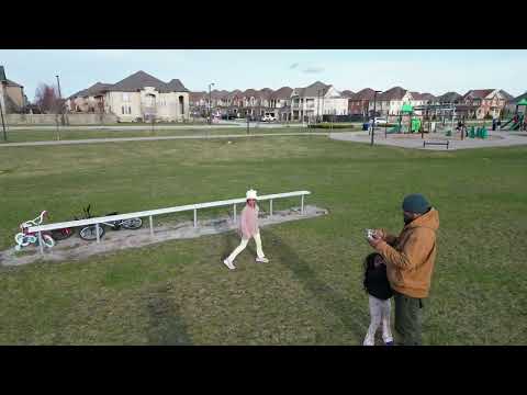 Running around in the park while drone following. Jenny and Toys