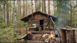 A man is doing simple roof repairs in an abandoned cabin in Siberia