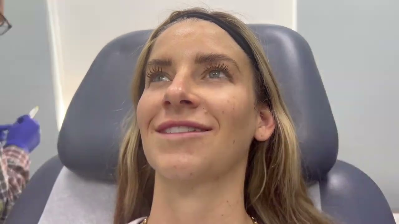 Woman with markings for cosmetic procedure preparation.