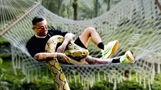 Man Chilling in a Hammock with Pet Python