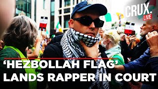 LIVE | Kneecap’s Mo Chara, Accused Of Waving ‘Hezbollah Flag,’ Appears In London Terror Case | Crux