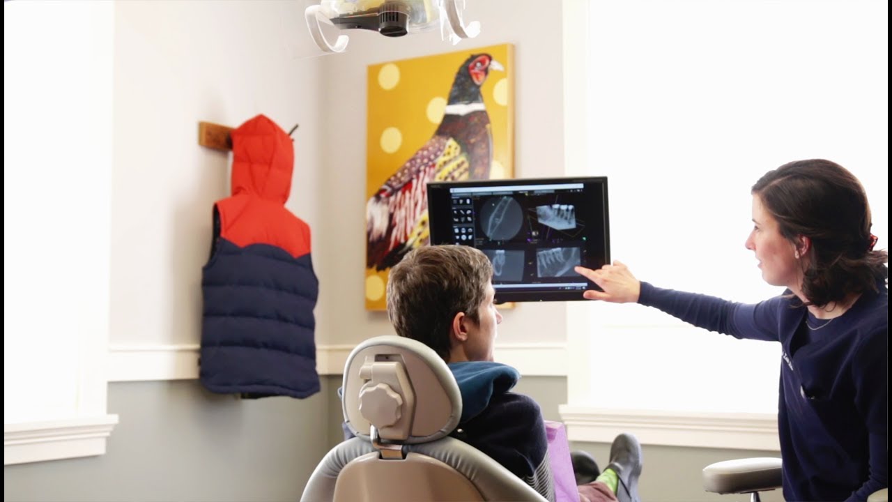 Endodontist showing a patient x rays of their teeth