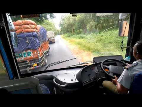 Volvo Bus Overtaking Heavy Load Lorry on a Narrow Forest Road