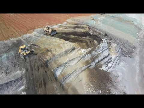 Caterpillar D9R Bulldozer And Komatsu D275 Pushing Soil On The Edge