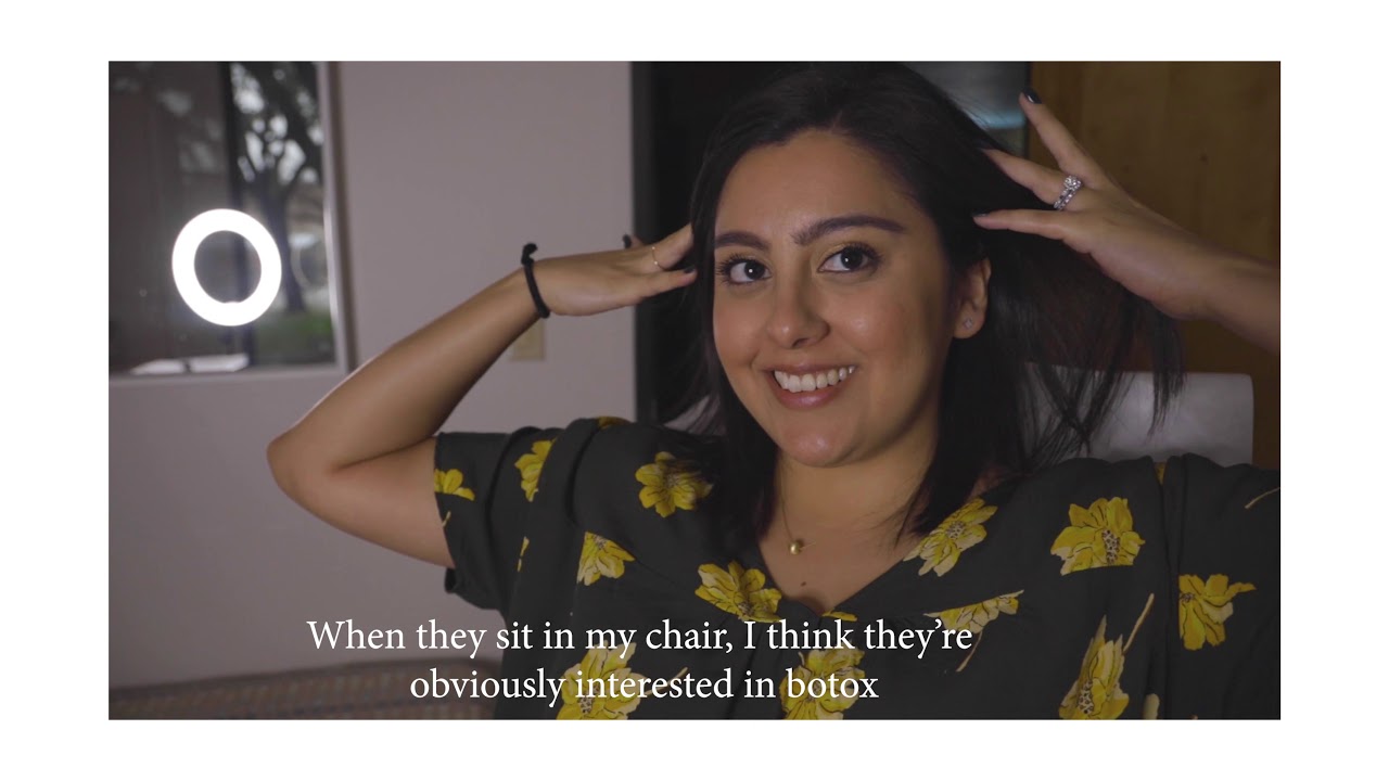 Woman smiling, discussing cosmetic procedures humorously.