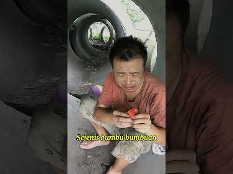 A homeless man licks the seasoning on his food