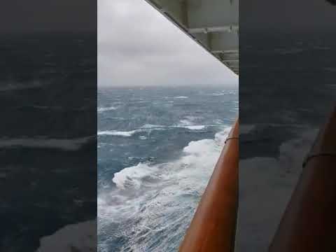 Cruise ship passing by a storm.