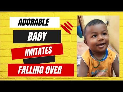 Adorable Baby Imitates Falling Over bed