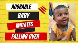 Adorable Baby Imitates Falling Over bed