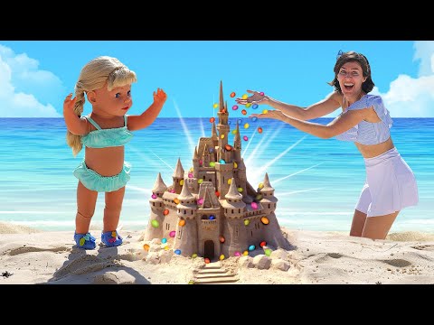 Amelia está construyendo un castillo en la playa. Juegos para niños. Como Mamá.