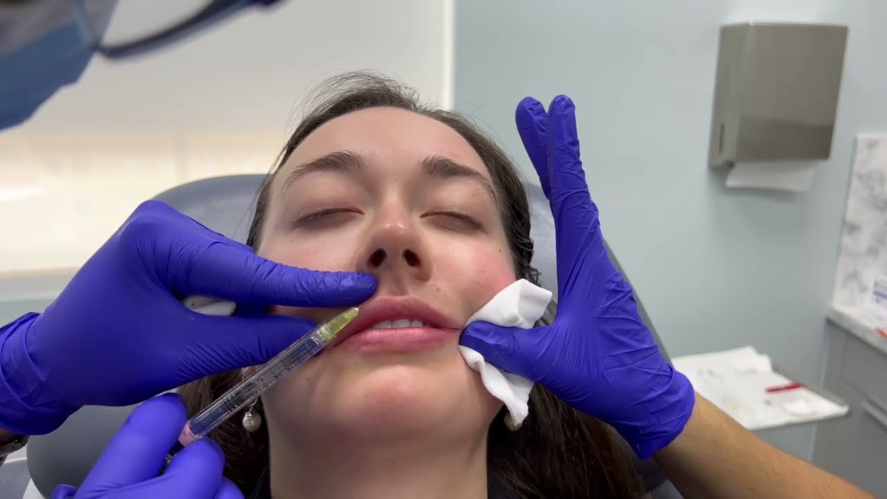Woman receiving skincare treatment in clinical setting.