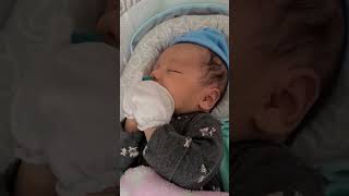 2 weeks old baby holding the pacifier.