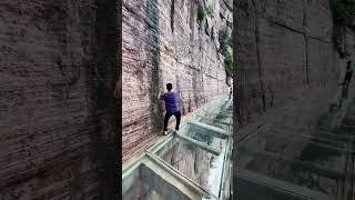 In this situation, is it safer to hold on to the wall or to hold on to the pole to climb the mou