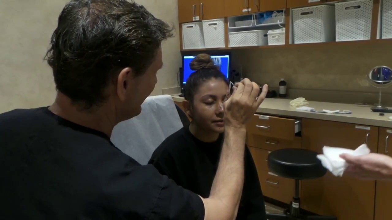 Doctor performing a procedure on a patient.