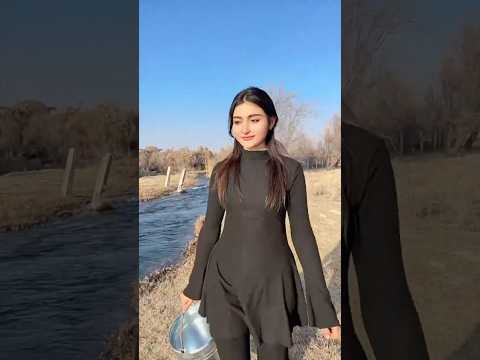 Village Life: Uyghur Girl Fills a Water Cube from the River in Winter