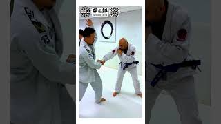 Over arm under hook grips takedown