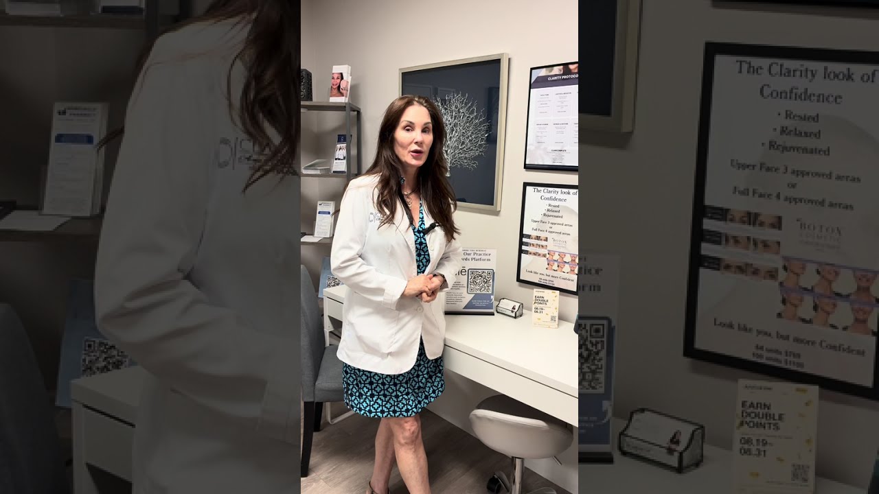 Doctor explaining aesthetic treatments in office setting.