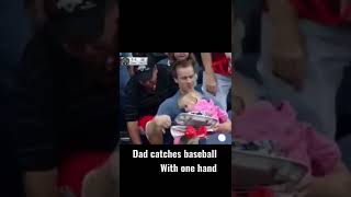 Dad catches ball with one hand and a child on his lap