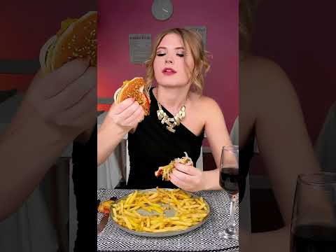 The girl eats a burger appetizingly💛