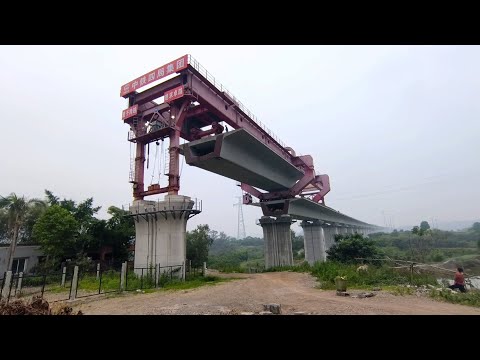 The beam truck came, the villagers around to watch the bridge erector unload the bridge