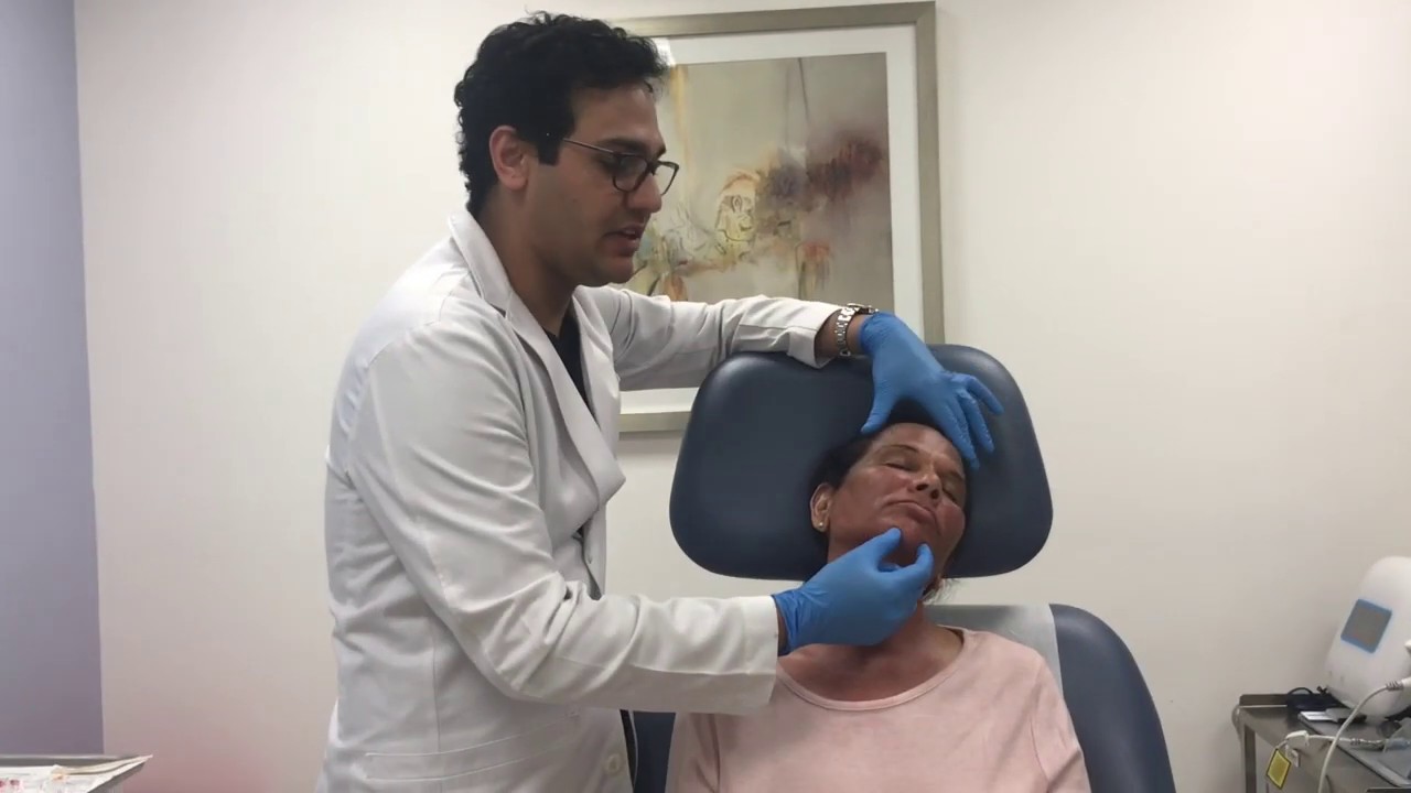 Patient receiving facial treatment in clinic setting.