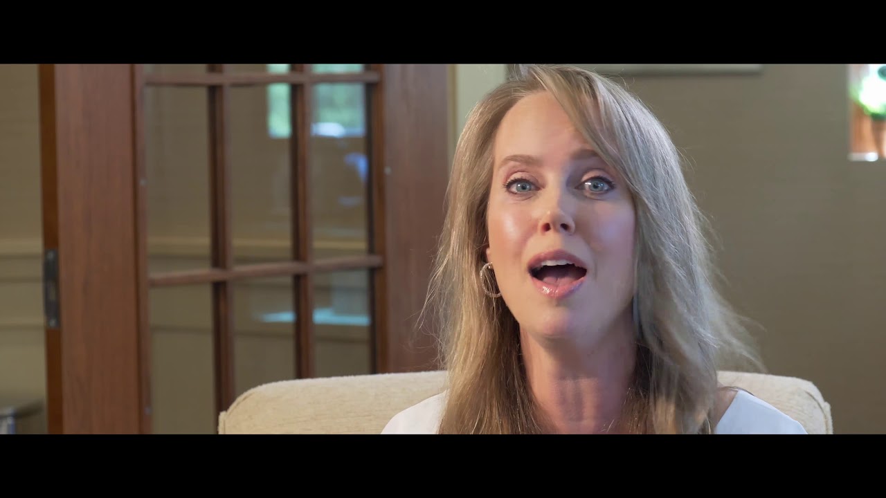 Woman speaking in a bright, welcoming environment.