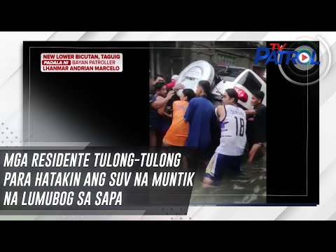 Mga residente tulong-tulong para hatakin ang SUV na muntik na lumubog sa sapa | TV Patrol