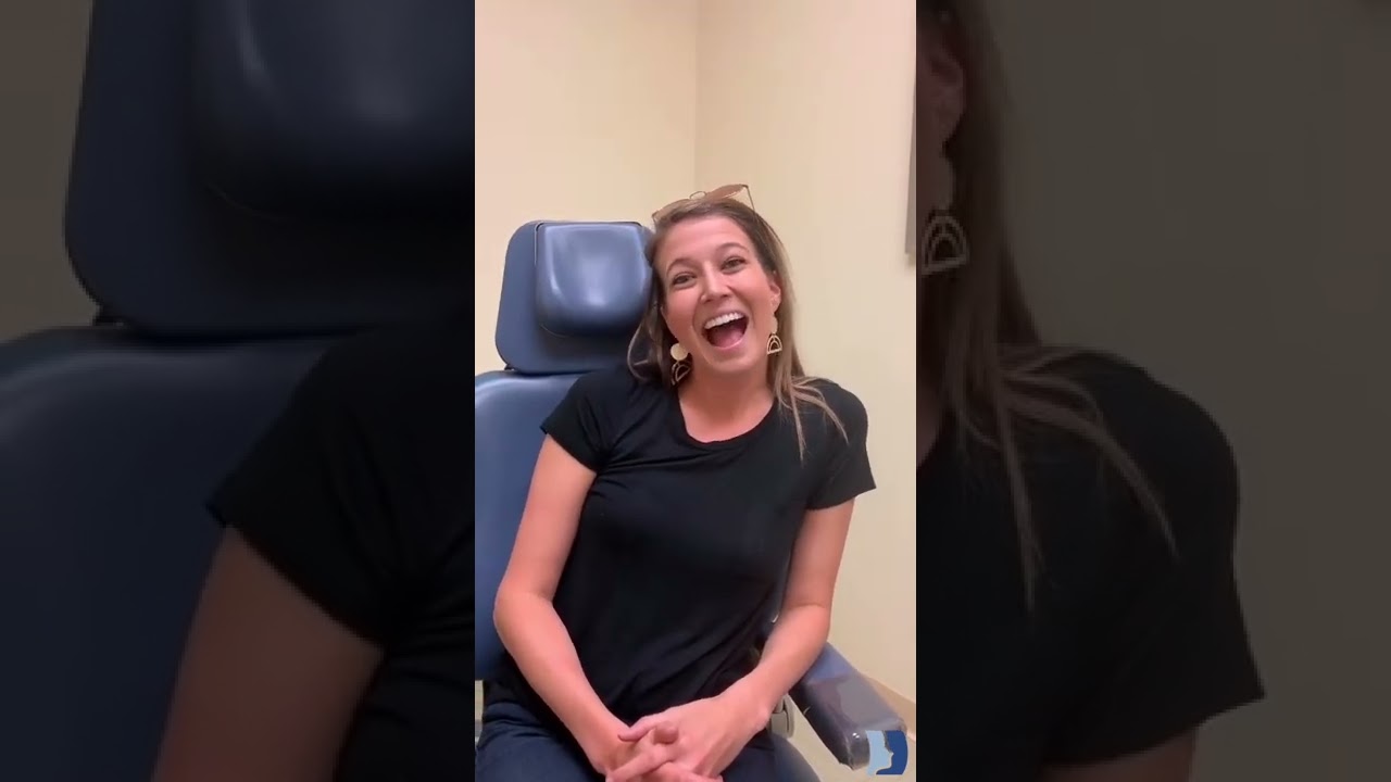 Smiling woman sitting in a medical office chair.