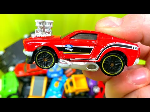 15 small selected cars from the box. Small plastic and metal cars in box