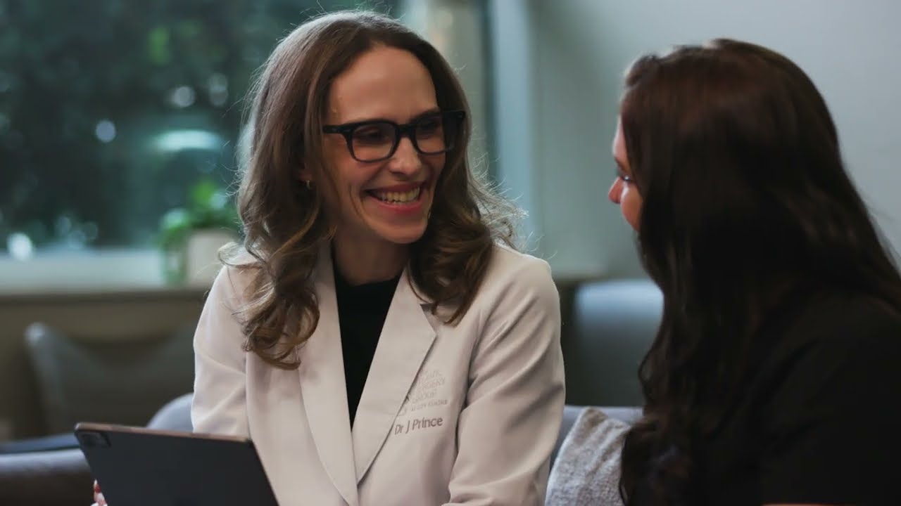 Doctor consulting with a patient, both smiling.