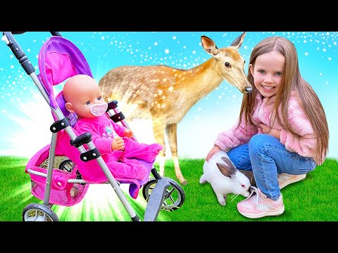 Maya searches for food for reindeer and goes for a walk with the Baby Born doll. Family fun videos.